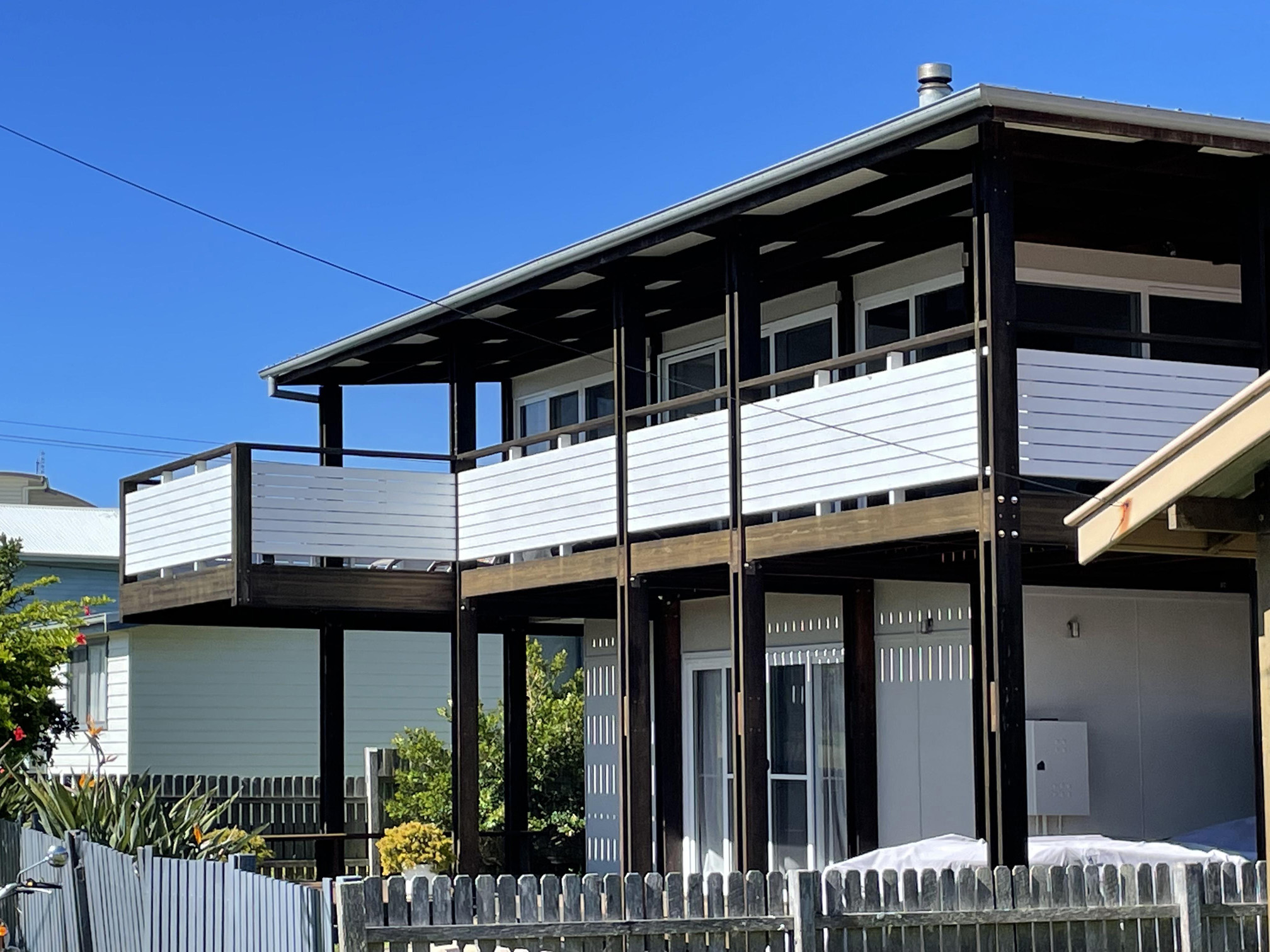 Beach house with cantilevered balcony.